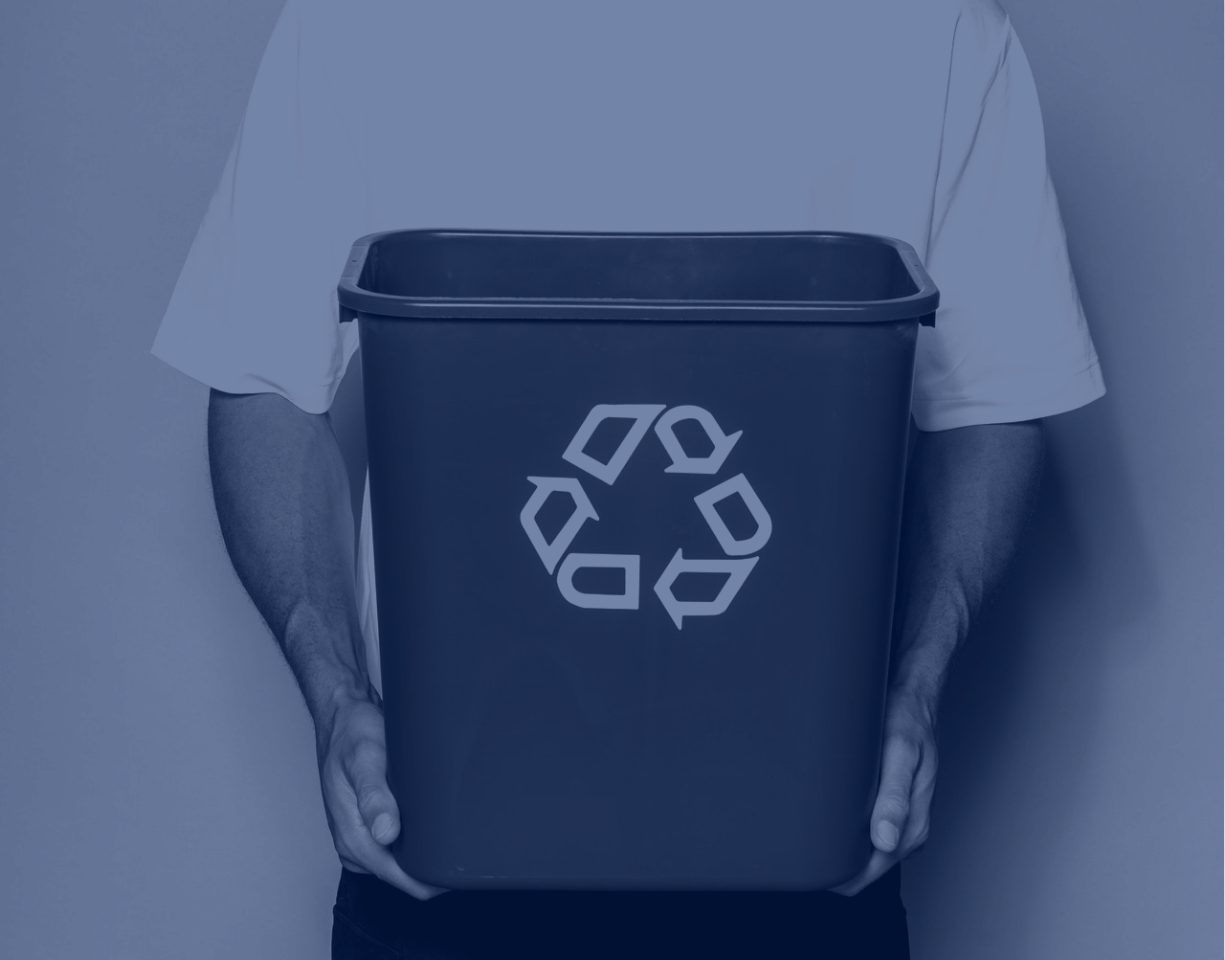 A man holding a recycling bin